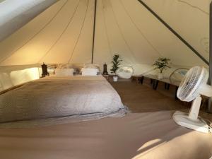 a bedroom with a bed in a tent at The Hidden Gem Viewpoint Camping & Rooms in Ban Nok