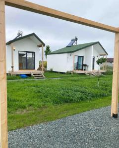a small white house with a green roof at Summer Home Corbu in Corbu