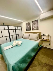 a bedroom with a large bed with two towels on it at Modern Home Loft in Alexandroupoli