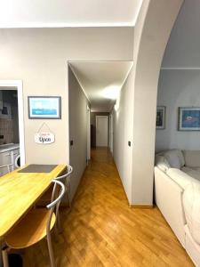 a living room with a table and a couch at Apartment in Luxury District in Genova