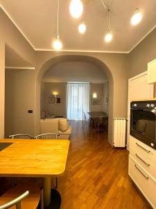 a living room with a table and a dining room at Apartment in Luxury District in Genova