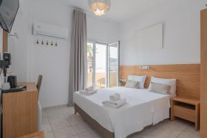 Postel nebo postele na pokoji v ubytování Theano Hotel