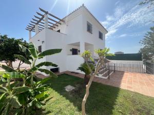 a view of a white house with a yard at Villa Espiga in Benalmádena