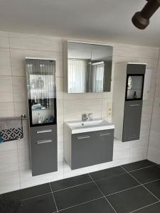 un baño con lavabo y espejo en Charming 2 Bedroom House with Cozy Attic in Scenic Ferschweiler Perfect for Families!, en Ferschweiler