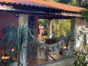 a hammock on the porch of a house at Casa de Campo Terra da Paz in Itatiba
