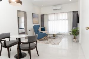 キンシャサにあるLux Inn Hotelのテーブルと椅子のあるリビングルーム