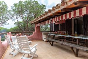 a patio with chairs and a table on a deck at Holiday Home Le Sirene in Fort Village