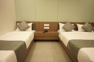 Letto o letti in una camera di A Square Executive Hotel