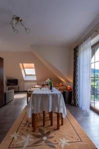 a living room with a table with a white table cloth at Hortensja Pokoje Gościnne in Krościenko +18 photos