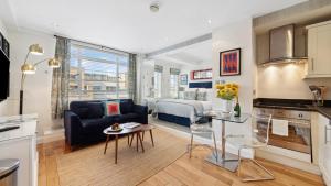 a kitchen and living room with a couch and a bed at Nell Gwynn Chelsea Accommodation in London +271 photos