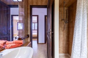 a bathroom with a tub and a shower and a sink at Holiday Home Le Sirene in Fort Village +75 photos