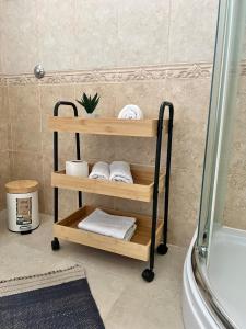 a wooden shelf with towels on it in a bathroom at Apartments Mrdak in Bar