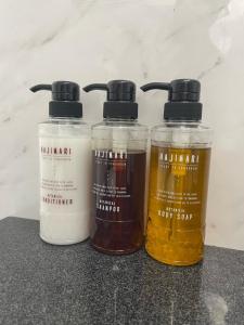 three bottles of honey sitting on top of a counter at Terminal Hotel Matsuyama in Matsuyama