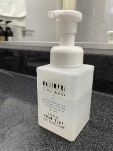 a white bottle of laundry detergent sitting on a counter at Terminal Hotel Matsuyama in Matsuyama