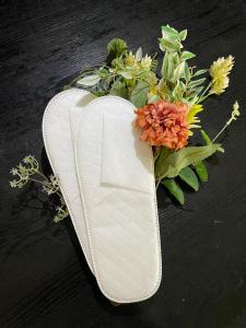a white shoe with a bouquet of flowers in it at Terminal Hotel Matsuyama in Matsuyama