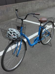 a blue bike with a basket parked on the street at Terminal Hotel Matsuyama in Matsuyama