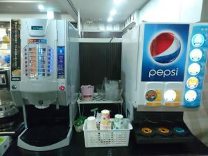 a pepsi machine in a kitchen with donuts at Terminal Hotel Matsuyama in Matsuyama