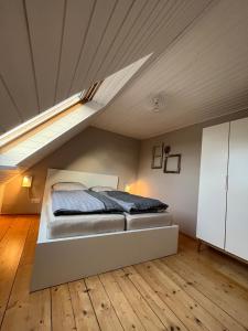 a bedroom with a bed in a attic at Fischerhus37 FeW Jasmund in Polchow