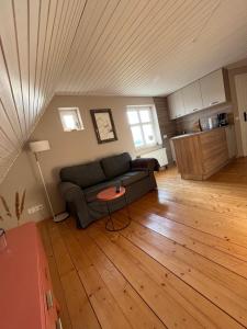 a living room with a couch and a table at Fischerhus37 FeW Jasmund in Polchow