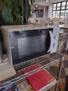 a microwave oven sitting on a rack in a room at Terminal Hotel Matsuyama in Matsuyama