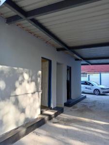 an empty parking lot with a door and a car at Qten City in Pietermaritzburg