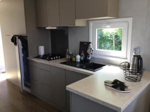 a kitchen with a stove and a counter top at Chalet Buitenhof 45A in Oegstgeest