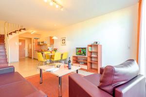 a living room with a couch and a table at Residenz Meeresblick D Fewo 17 in Rerik