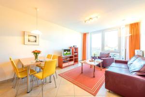 a living room with a couch and a table at Residenz Meeresblick D Fewo 17 in Rerik