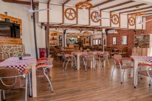 a restaurant with tables and chairs in a room at Villa Ljupce in Ohrid