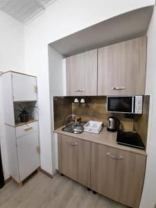 a small kitchen with a sink and a microwave at Viccinella House in Capranica +14 photos