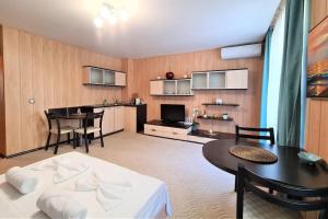 a living room with a table and a dining room at MATEO Golden Sands 2 in Golden Sands +2 photos