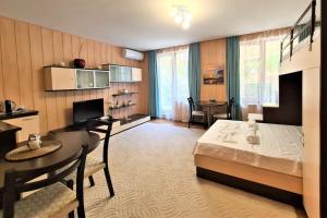 a bedroom with a bed and a desk and a table at MATEO Golden Sands 2 in Golden Sands
