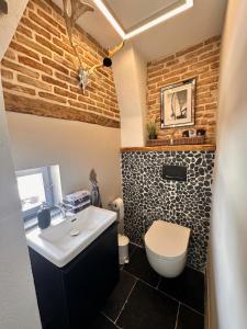 a bathroom with a white sink and a toilet at Casa Blanca Seaview in Rovinj +26 photos