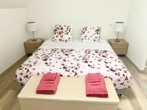 a bedroom with a bed with red towels on it at La BULLE du 235 in Cramant +7 photos