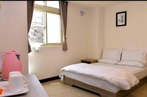 Postel nebo postele na pokoji v ubytování Xiangbin B&B