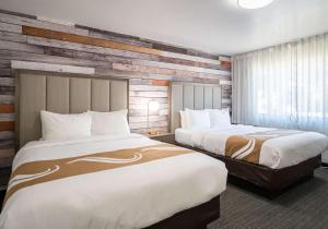 a hotel room with two beds and a window at Quality Inn South Lake Tahoe in South Lake Tahoe