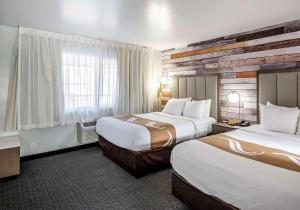 a hotel room with two beds and a window at Quality Inn South Lake Tahoe in South Lake Tahoe