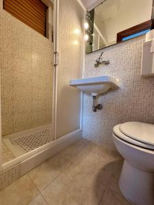 a bathroom with a shower and a toilet and a sink at Sea View Apartment in Gallipoli