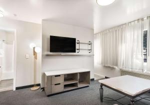 a living room with a tv on a white wall at Quality Inn South Lake Tahoe in South Lake Tahoe
