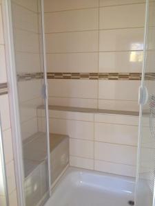 a shower with a glass door in a bathroom at Rael-Boardinghouse in Bielefeld