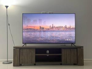 a flat screen tv sitting on top of a wooden entertainment center at Stockmans in Truganina