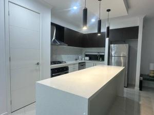 a kitchen with a white counter top in a room at Stockmans in Truganina