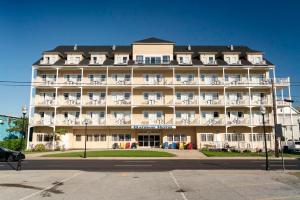 a large building with white chairs in front of it at Gateway Hotel & Suites, an Ascend Collection Hotel in Ocean City