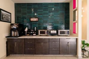a kitchen with two microwaves on a counter at Gateway Hotel & Suites, an Ascend Collection Hotel in Ocean City