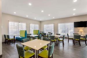 a waiting room with tables and chairs and a flat screen tv at Quality Inn Cookeville in Cookeville