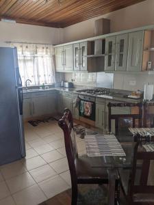 a kitchen with white cabinets and a table and a refrigerator at Brookville in Georgetown