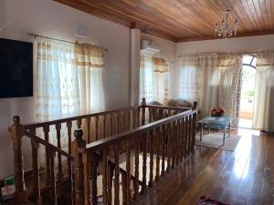 a wooden staircase in a living room with windows at Brookville in Georgetown