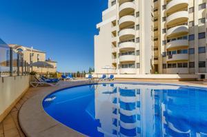 una grande piscina di fronte a un edificio di TURIM Algarve Mor Apartamentos Turísticos a Portimão