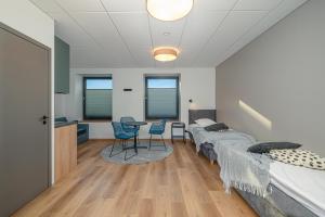 a bedroom with two beds and a table and chairs at Betooni Stay in Tartu