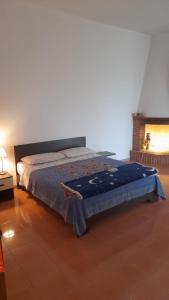 a bedroom with a bed with a blue blanket on it at Gemma del salento in Sternatia
